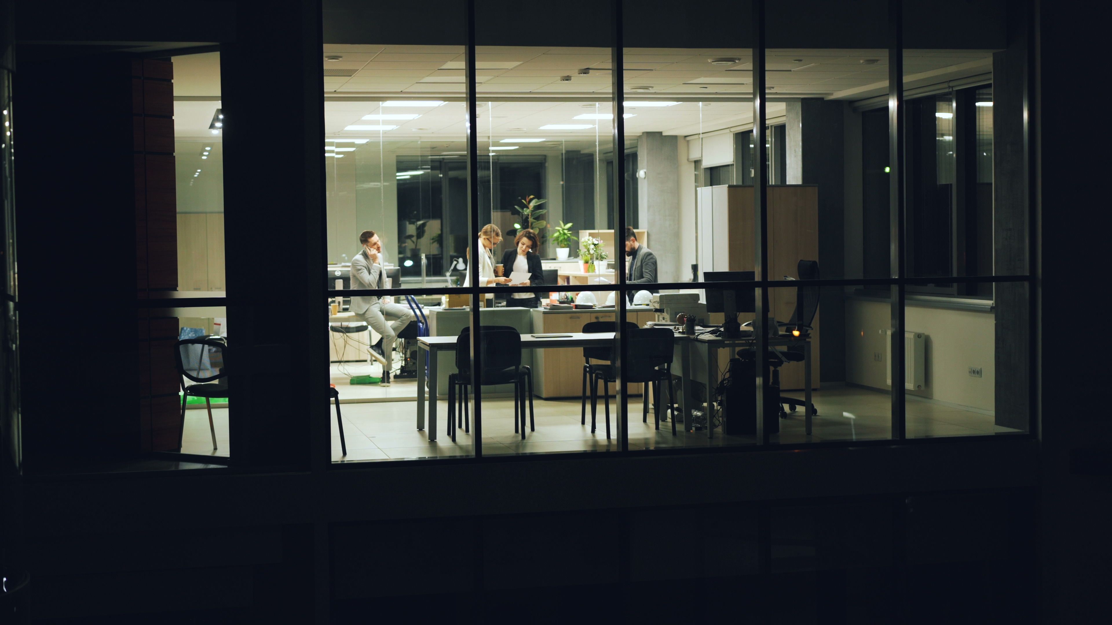 Practitioners at work in a focused, low-light office